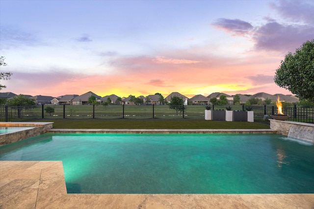 19534 Juniper Breeze Ln, Spring, TX 77379 - pool at dusk featuring a residential view and a pool with connected hot tub