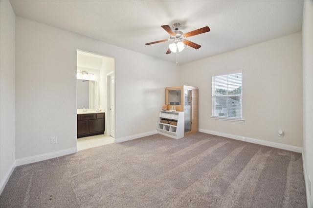 19534 Juniper Breeze Ln, Spring, TX 77379 - unfurnished bedroom with light carpet, baseboards, connected bathroom, and a ceiling fan