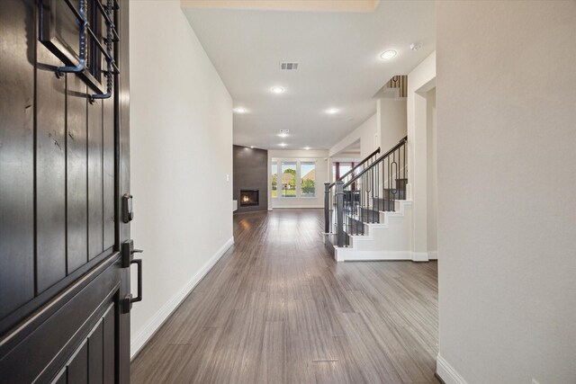 19534 Juniper Breeze Ln, Spring, TX 77379 - foyer entrance featuring baseboards, dark wood-type flooring, stairway, a fireplace, and recessed lighting