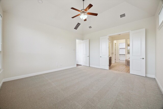 19534 Juniper Breeze Ln, Spring, TX 77379 - unfurnished bedroom featuring light colored carpet, baseboards, lofted ceiling, connected bathroom, and a ceiling fan