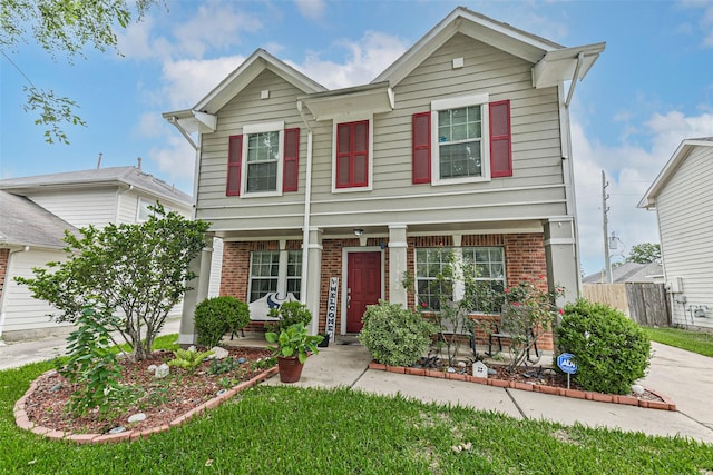 19942 Crested Hill Ln, Cypress, TX 77433 - view of front of home featuring brick siding, a porch, and fence