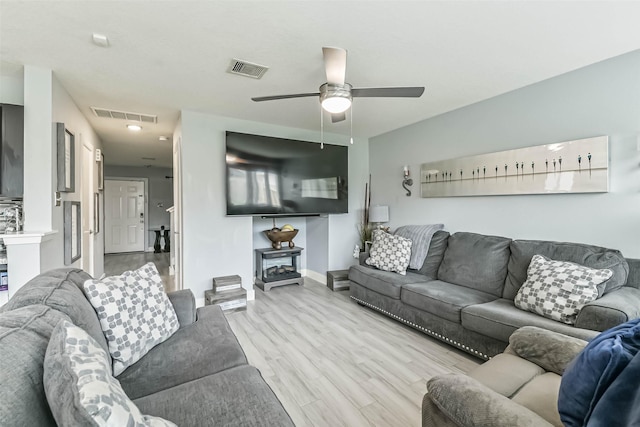 19942 Crested Hill Ln, Cypress, TX 77433 - living room featuring baseboards, light wood-style flooring, and a ceiling fan