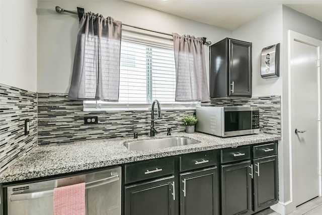 19942 Crested Hill Ln, Cypress, TX 77433 - kitchen featuring stainless steel appliances, a sink, tasteful backsplash, and light stone countertops