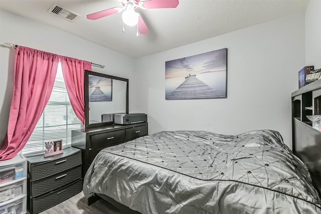 19942 Crested Hill Ln, Cypress, TX 77433 - bedroom featuring wood finished floors and a ceiling fan