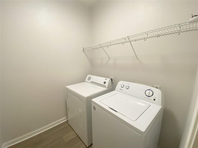 2702 Orchard Creek Ln, Katy, TX 77494 - laundry area featuring washer and dryer, wood finished floors, and baseboards