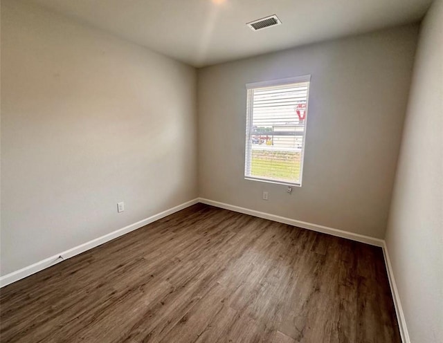 501-509 Hines Ave, Willis, TX 77378 - spare room featuring dark wood finished floors and baseboards