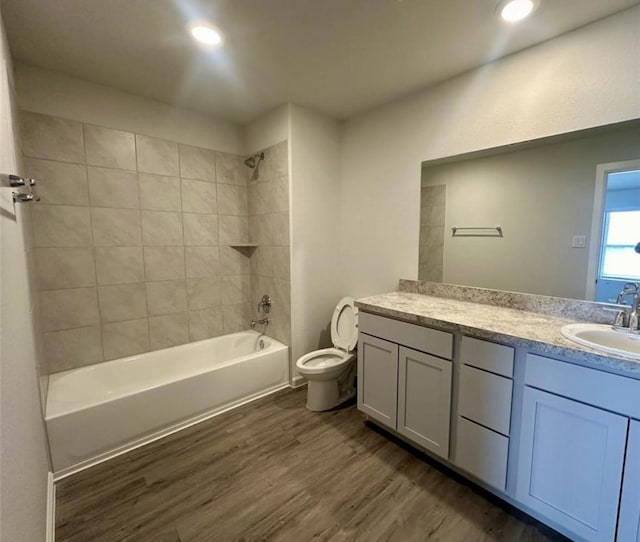 501-509 Hines Ave, Willis, TX 77378 - bathroom featuring wood finished floors, vanity, toilet, washtub / shower combination, and recessed lighting