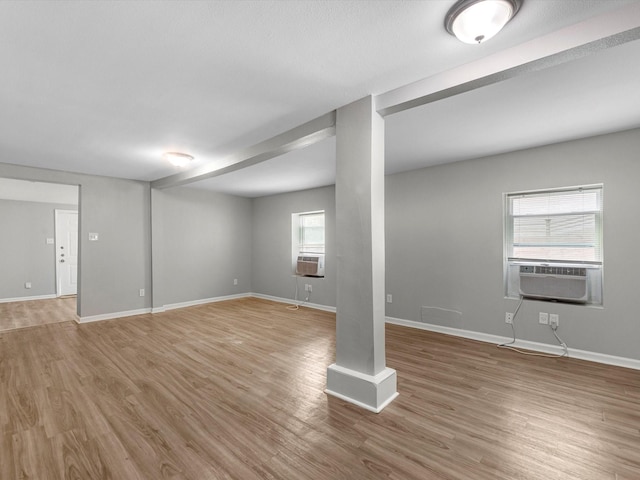1811 39th St, Galveston, TX 77550 - below grade area with light wood finished floors, cooling unit, and baseboards