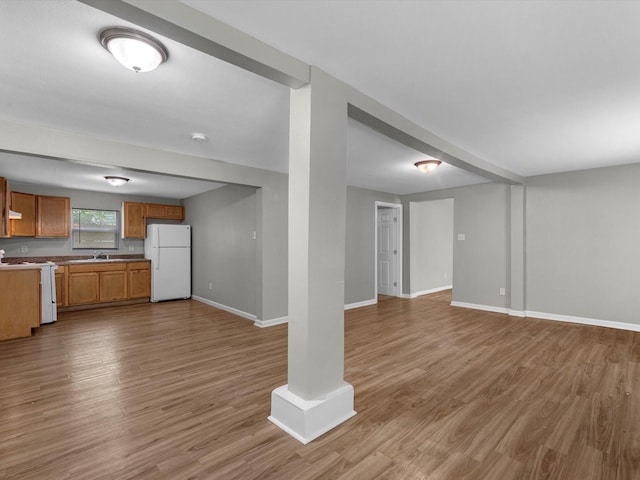 1811 39th St, Galveston, TX 77550 - unfurnished living room featuring wood finished floors, baseboards, and a sink