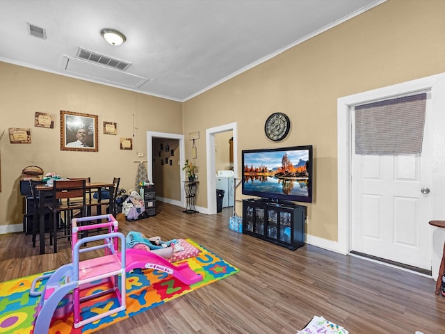 1811 39th St, Galveston, TX 77550 - game room featuring attic access, washing machine and clothes dryer, crown molding, wood finished floors, and baseboards