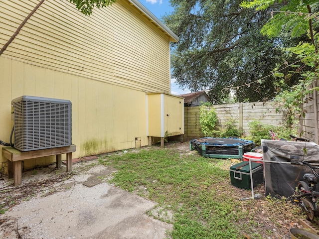 1811 39th St, Galveston, TX 77550 - view of yard featuring central AC, fence, and a storage shed