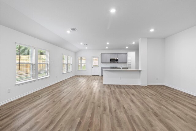 12672 Lake Conroe Hls, Conroe, TX 77318 - unfurnished living room with light wood-style floors and recessed lighting