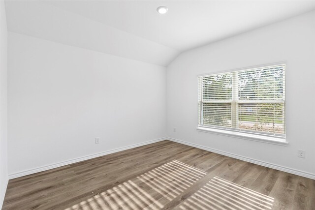 12672 Lake Conroe Hls, Conroe, TX 77318 - spare room featuring lofted ceiling and wood finished floors
