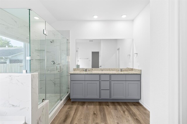 12672 Lake Conroe Hls, Conroe, TX 77318 - bathroom with a marble finish shower, wood finished floors, double vanity, and recessed lighting