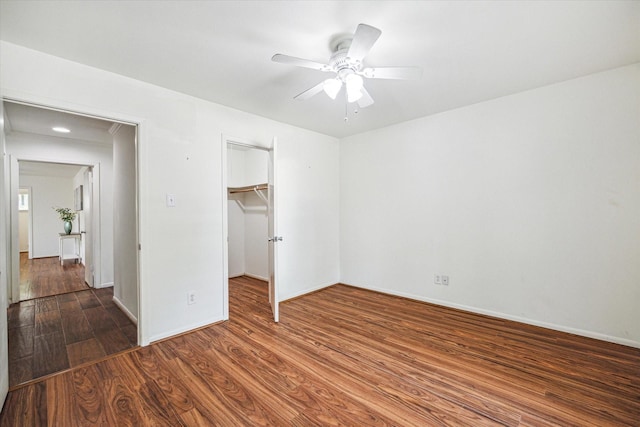 5939 Rutherglenn Dr, Houston, TX 77096 - unfurnished bedroom featuring wood finished floors, a closet, baseboards, ceiling fan, and a walk in closet