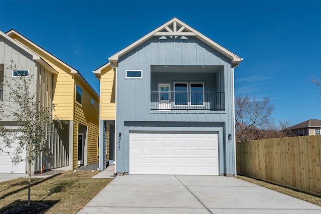 2020 Wavell St, Houston, TX 77088 - view of front facade with board and batten siding, fence, driveway, and an attached garage