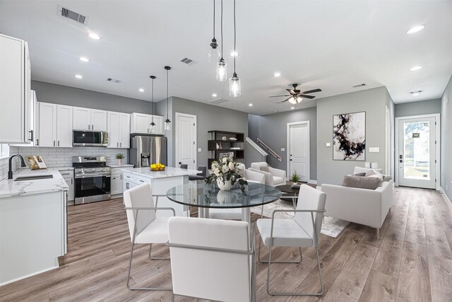 2020 Wavell St, Houston, TX 77088 - dining area featuring light wood finished floors, ceiling fan, recessed lighting, and baseboards