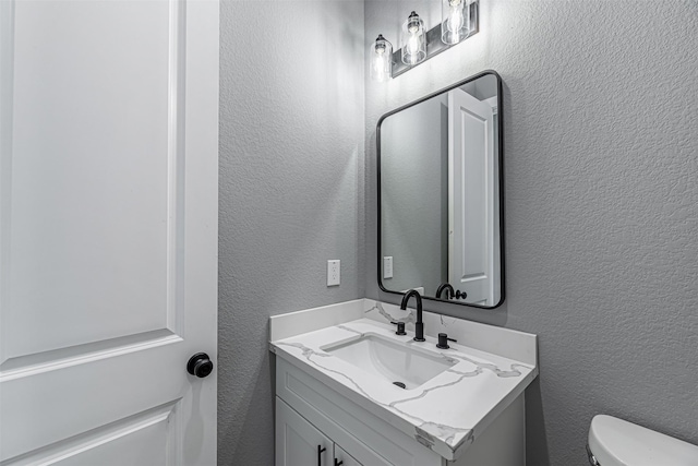2020 Wavell St, Houston, TX 77088 - half bath featuring a textured wall, vanity, and toilet