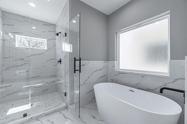 2020 Wavell St, Houston, TX 77088 - full bathroom with a freestanding tub, a marble finish shower, a wainscoted wall, recessed lighting, and marble finish flooring