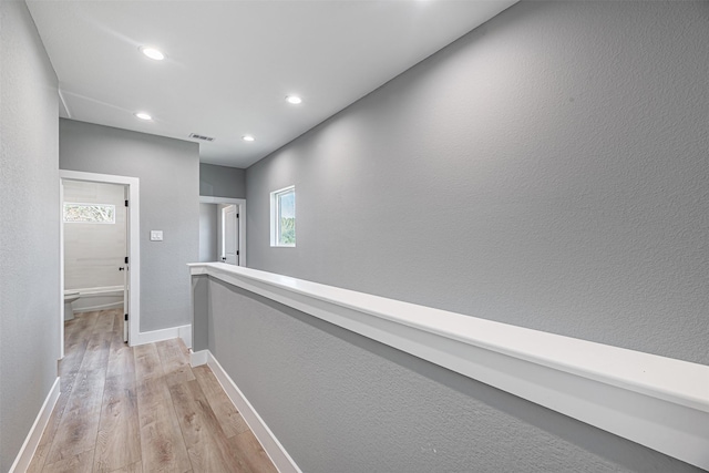 2020 Wavell St, Houston, TX 77088 - corridor featuring light wood-style floors, baseboards, recessed lighting, and an upstairs landing