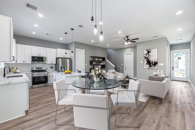 2022 Wavell St, Houston, TX 77088 - dining area featuring light wood-style flooring, a ceiling fan, recessed lighting, and baseboards