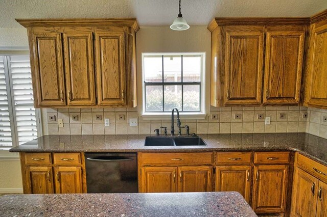 108 Madison Ave, Clute, TX 77531 - kitchen featuring a sink, black dishwasher, brown cabinets, backsplash, and pendant lighting