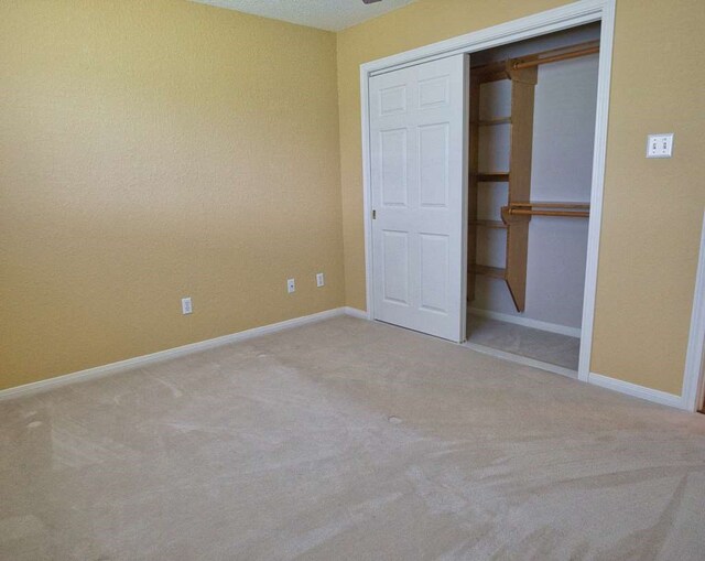 108 Madison Ave, Clute, TX 77531 - unfurnished bedroom featuring carpet, baseboards, and a closet