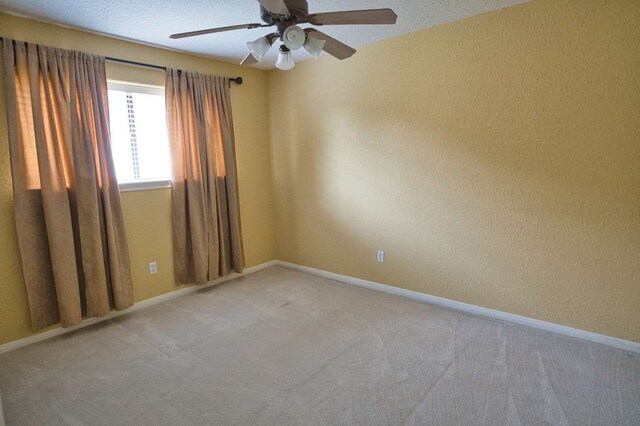 108 Madison Ave, Clute, TX 77531 - empty room featuring light colored carpet, a ceiling fan, and baseboards