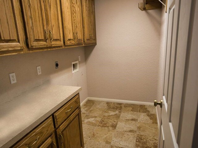 108 Madison Ave, Clute, TX 77531 - laundry room featuring electric dryer hookup, cabinet space, hookup for a washing machine, baseboards, and light stone finish flooring