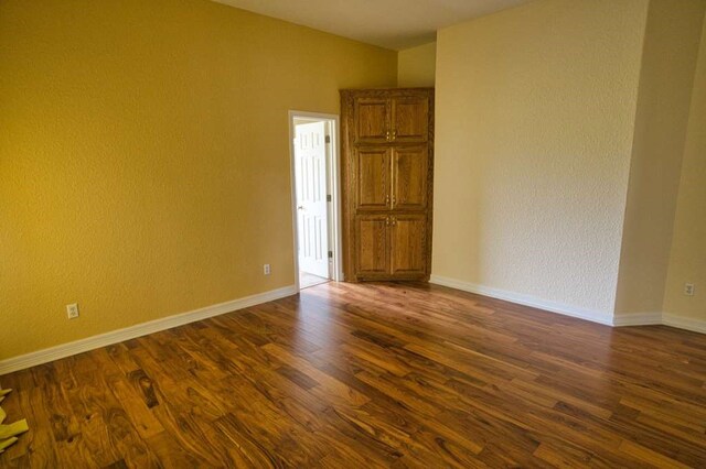 108 Madison Ave, Clute, TX 77531 - unfurnished room featuring dark wood-style flooring and baseboards