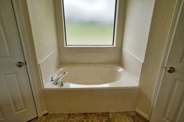 108 Madison Ave, Clute, TX 77531 - bathroom with a textured wall and a jetted tub