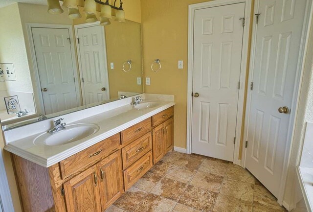 108 Madison Ave, Clute, TX 77531 - full bath featuring double vanity, stone finish flooring, and baseboards