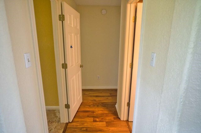 108 Madison Ave, Clute, TX 77531 - hallway featuring wood finished floors and baseboards