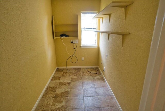 108 Madison Ave, Clute, TX 77531 - laundry area featuring a textured wall and baseboards