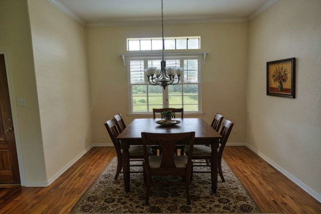 108 Madison Ave, Clute, TX 77531 - dining room featuring dark wood-style floors, a chandelier, baseboards, and ornamental molding