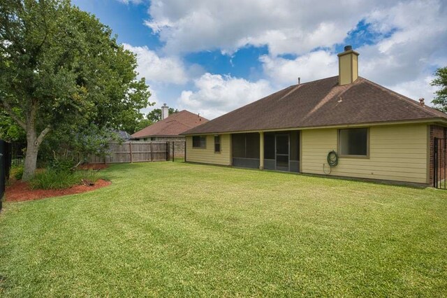 108 Madison Ave, Clute, TX 77531 - back of property with a chimney, roof with shingles, and a sunroom