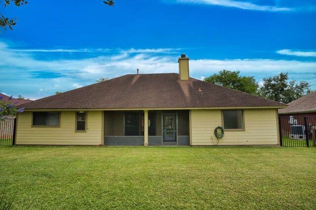 108 Madison Ave, Clute, TX 77531 - back of property featuring a chimney, a sunroom, and a shingled roof