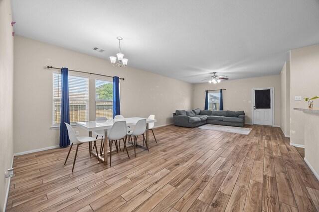 6026 Coleus St, Crosby, TX 77532 - dining space with light wood-type flooring, a chandelier, ceiling fan, and baseboards