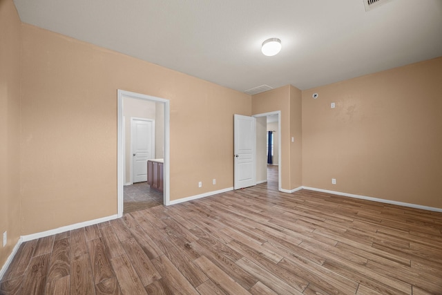 6026 Coleus St, Crosby, TX 77532 - unfurnished bedroom featuring light wood-style flooring, baseboards, and ensuite bath