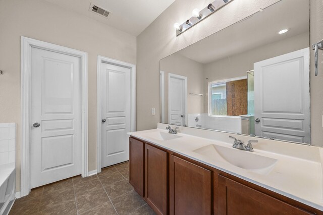 6026 Coleus St, Crosby, TX 77532 - bathroom with double vanity, a tub, and tile patterned floors