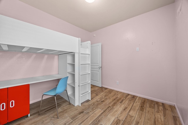 6026 Coleus St, Crosby, TX 77532 - unfurnished bedroom featuring wood finished floors and baseboards