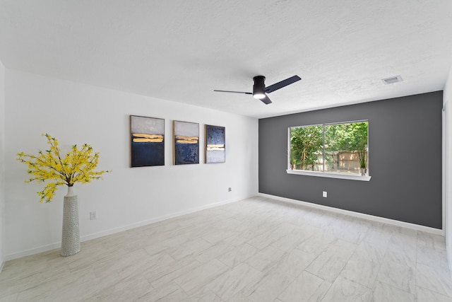 7511 Londres Dr, Houston, TX 77083 - empty room with a ceiling fan, a textured ceiling, and baseboards