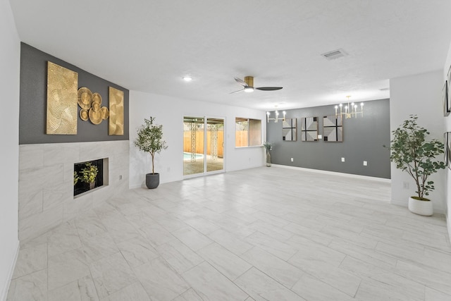 7511 Londres Dr, Houston, TX 77083 - unfurnished living room with ceiling fan, a chandelier, a tile fireplace, and baseboards