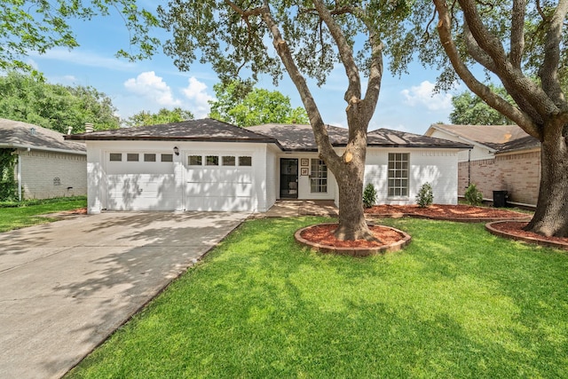 7511 Londres Dr, Houston, TX 77083 - ranch-style home featuring an attached garage, driveway, a front yard, and brick siding