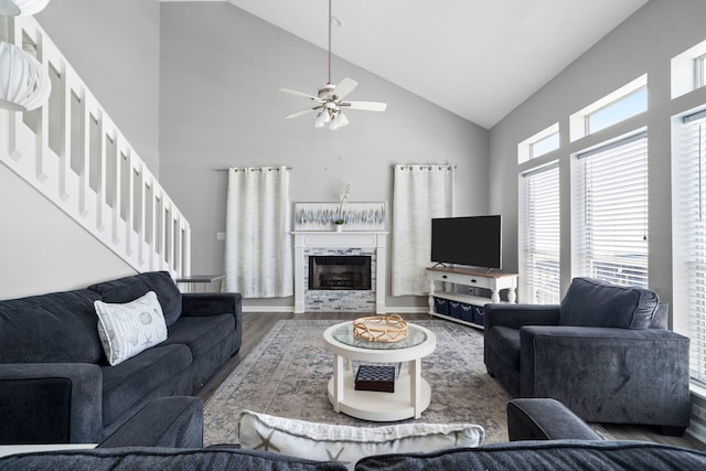 23401 Termini San Luis Pass Rd, Galveston, TX 77554 - living room with high vaulted ceiling, wood finished floors, a ceiling fan, stairway, and a premium fireplace