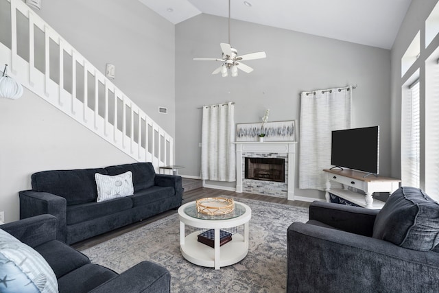23401 Termini San Luis Pass Rd, Galveston, TX 77554 - living room featuring wood finished floors, stairs, ceiling fan, high vaulted ceiling, and a high end fireplace