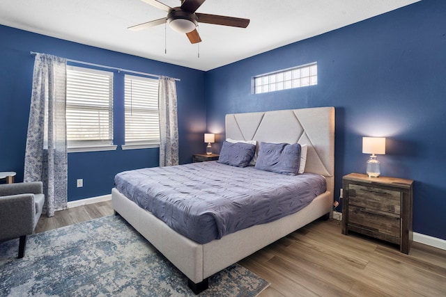 23401 Termini San Luis Pass Rd, Galveston, TX 77554 - bedroom with multiple windows, wood finished floors, baseboards, and a ceiling fan