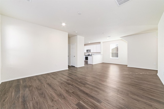 5810 Dry Brush Pl, Katy, TX 77493 - unfurnished living room with dark wood-style flooring, baseboards, and recessed lighting