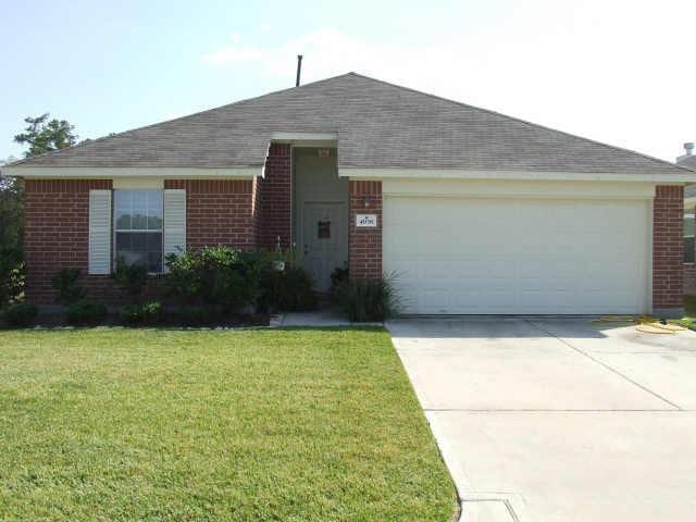 4938 Winding View Ln, Humble, TX 77346 - ranch-style house with brick siding, a garage, concrete driveway, and a front yard