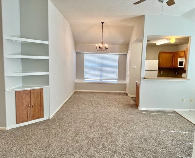 4938 Winding View Ln, Humble, TX 77346 - unfurnished living room featuring carpet floors, baseboards, ceiling fan, and vaulted ceiling